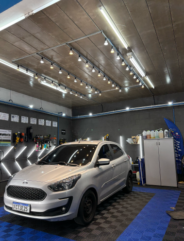 Carro prata no estúdio da JC Estética Automotiva durante lavagem de motor